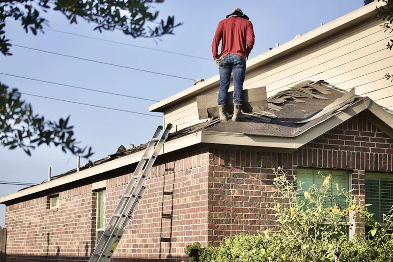 Professional roofer working on a residential roof in Lockbourne